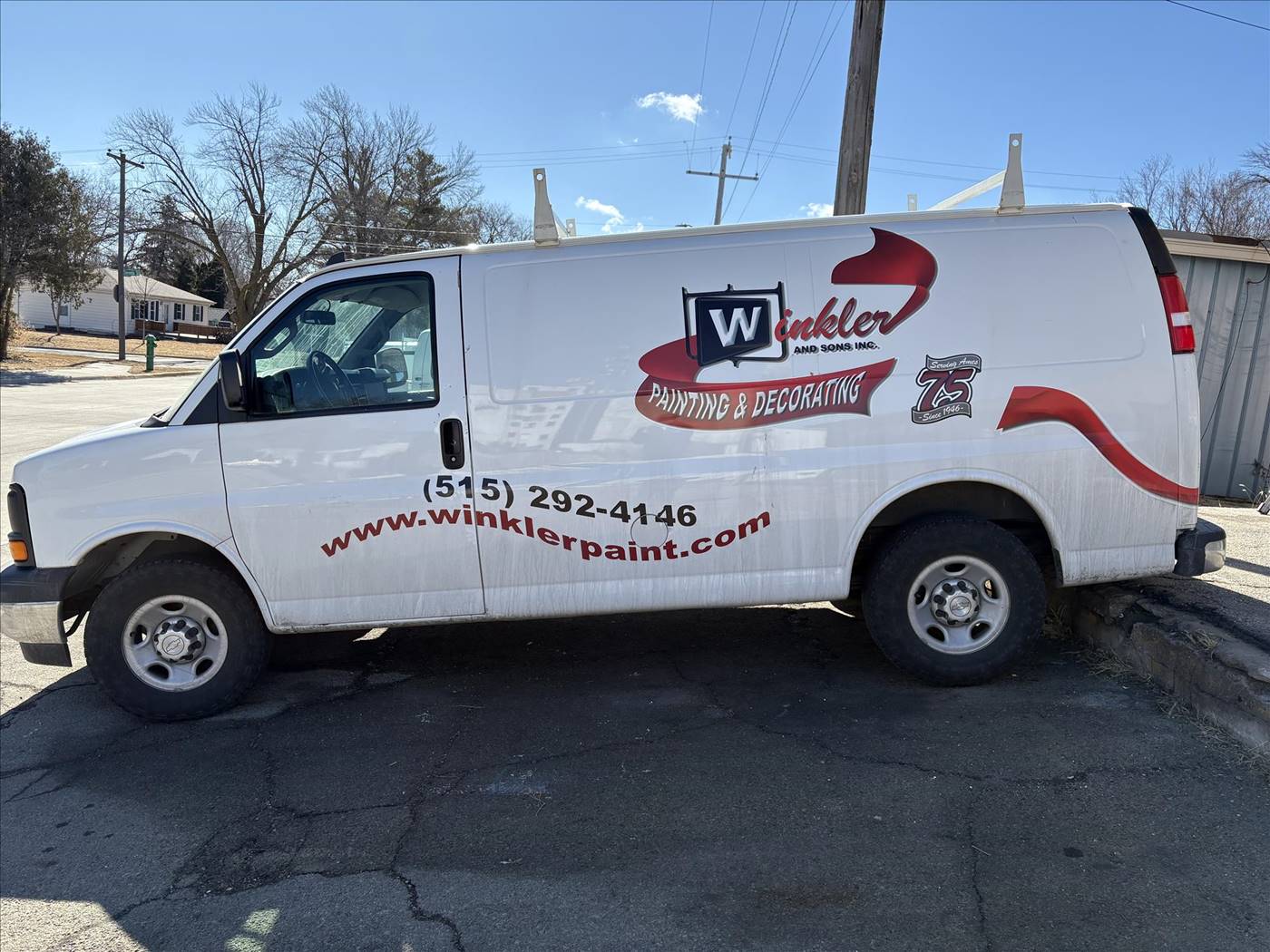 The lettered Winkler & Sons work van parked on an Ames street